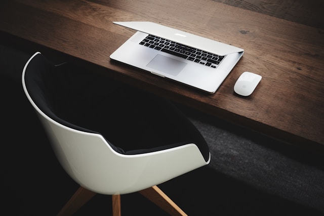 White chair and laptop on a wooden desk